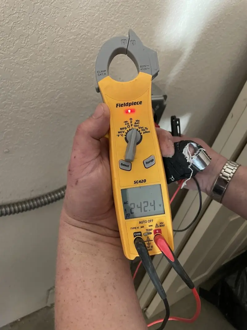 Voltage testing with clamp meter during Outlet Installation in Bedford